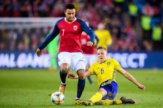 Joshua King of Norway in action with Ludwig Augustinsson of