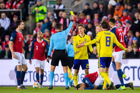 Kristoffer Olsson of Sweden is shown a yellow card