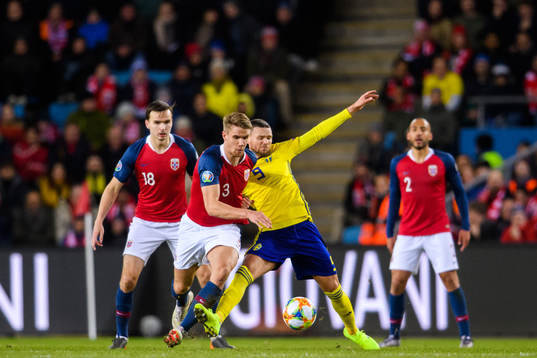 Kristoffer Ajer of Norway in action with Marcus Berg of