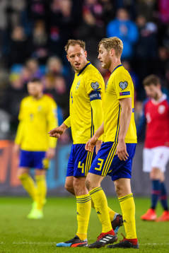 Andreas Granqvist and Filip Helander of Sweden looks