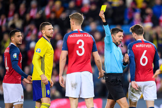 Kristoffer Ajer of Norway is shown a yellow card by Referee