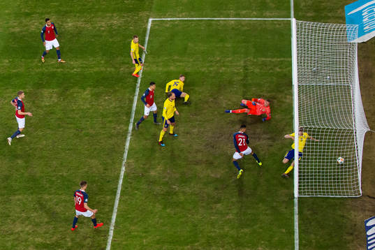 Bjørn Maars Johnsen of Norway scores 1-0 behind goalkeeper