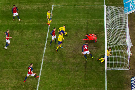 Bjørn Maars Johnsen of Norway scores 1-0 behind goalkeeper