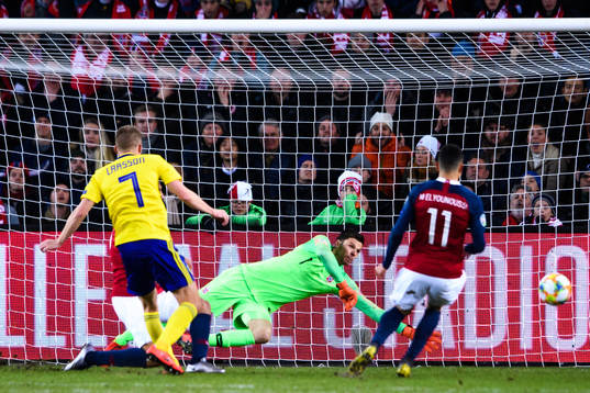 Sebastian Larsson of Sweden against goalkeeper Rune