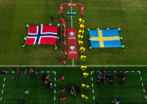 Players of Norway and of Sweden enter the pitch