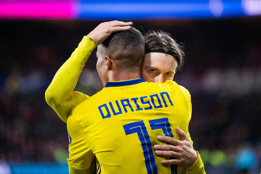 Kristoffer Olsson embrace Robin Quaison of Sweden as they
