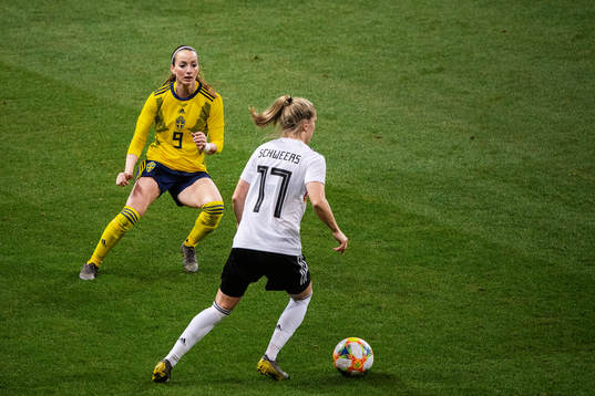 Kosovare Asllani of Sweden and Verena Schweers of Germany
