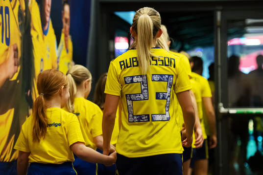 Elin Rubensson of Sweden enter the field in hand with a