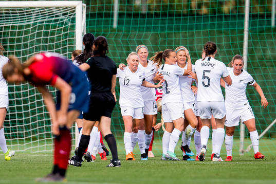Rosie White of New Zealand celebrates with teammates Betsy