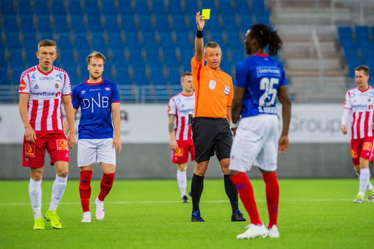 Sam Adekugbe of Vålerenga is shown a yellow card bye Svein