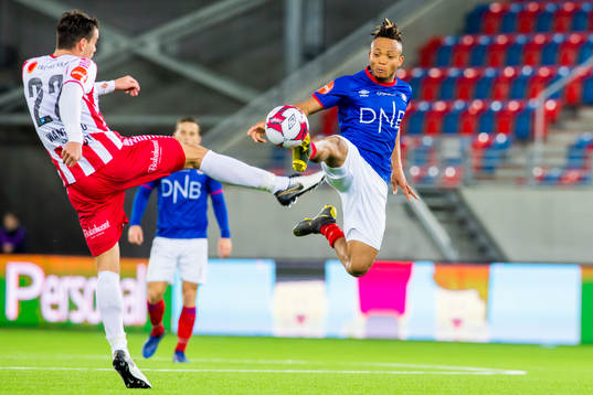 Simen Wangberg of Tromsø and Chidera Ejuke of Vålerenga