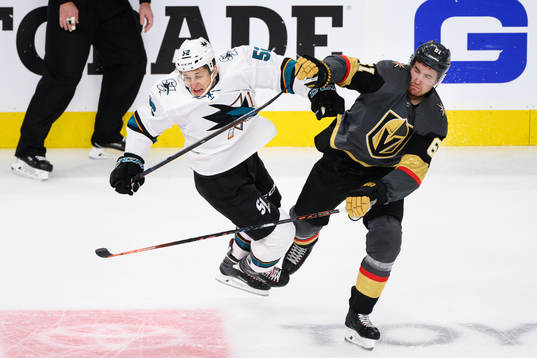 Lukas Radil of San Jose Sharks gets tackled by Mark Stone