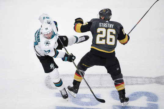 Joonas Donskoi of San Jose Sharks gets tackled by Paul