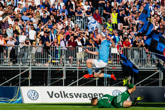 Sirius målvakt Lukas Jonsson tar bollen framför Malmö