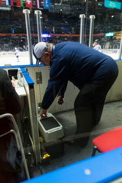 Stefan Åsander delivers a new cold puck to the referee