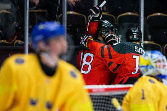 Connor Zary of Canada celebrate with team mates