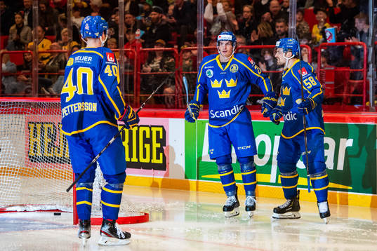 Loui Eriksson celebrate with Elias Pettersson and Anton