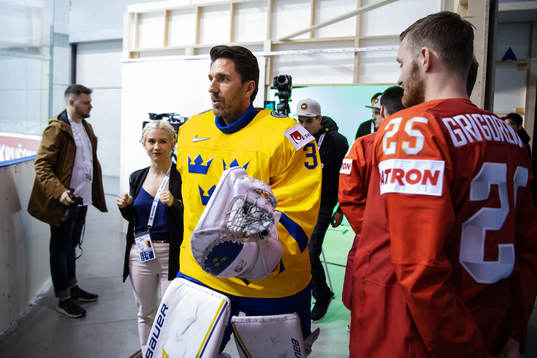 Goaltender Henrik Lundqvist of Sweden passes by Mikhail