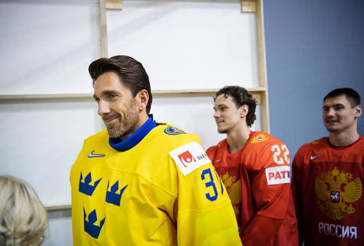 Goaltender Henrik Lundqvist of Sweden in front of Russian