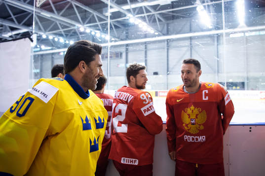 Goaltender Henrik Lundqvist of Sweden greets Ilya Kovalchuk