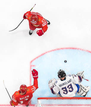 Yevgeni Dadonov and Evgeni Malkin of Russia celebrate the