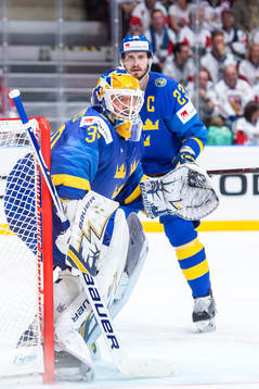Oliver Ekman Larsson and goaltender Henrik Lundqvist of