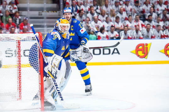 Oliver Ekman Larsson and goaltender Henrik Lundqvist of