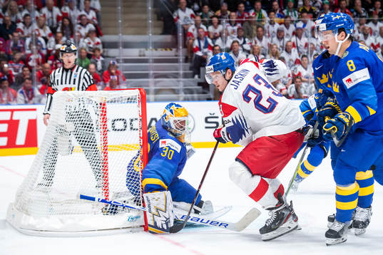 Robert Hägg and goaltender Henrik Lundqvist of Sweden