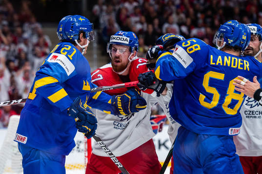 Loui Eriksson and Anton Lander  of Sweden fights Michal