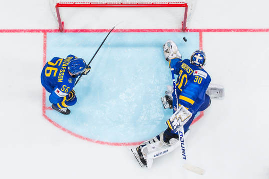 Erik Gustafsson and goaltender Henrik Lundqvist of Sweden