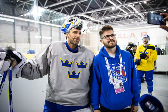 Goaltender Henrik Lundqvist of Sweden and a fan