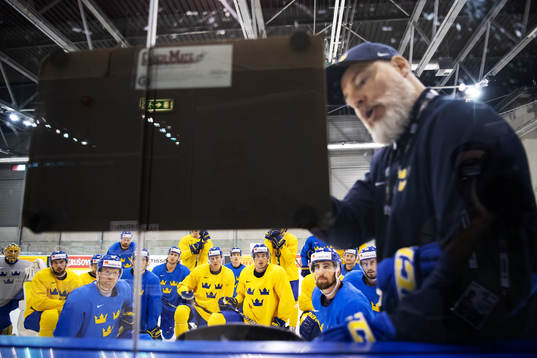 Players of Sweden listen to head coach Rikard Grönborg at