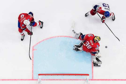 Erlend Lesund and goaltender Henrik Holm of Norway against