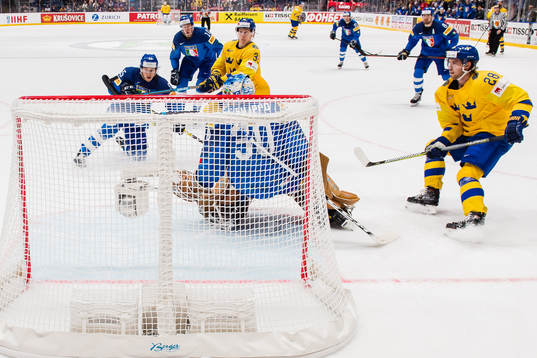 Oskar Lindblom and Elias Lindholm of Sweden and goaltender