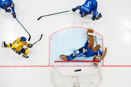 Oskar Lindblom of Sweden scores 0-3 behind goaltender Marco