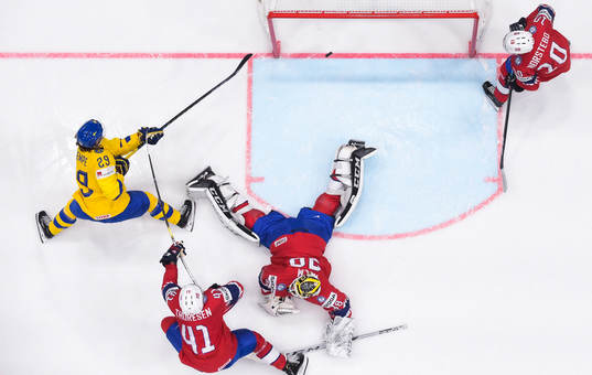 Mario Kempe of Sweden scores the 0-6 goal behind goaltender