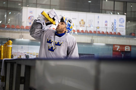 Goaltender Henrik Lundqvist of Sweden drinks water at a