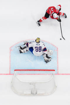 Andres Ambuhl of Switzerland scores 1-0 behind goaltender