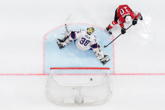 Andres Ambuhl of Switzerland scores 1-0 behind goaltender