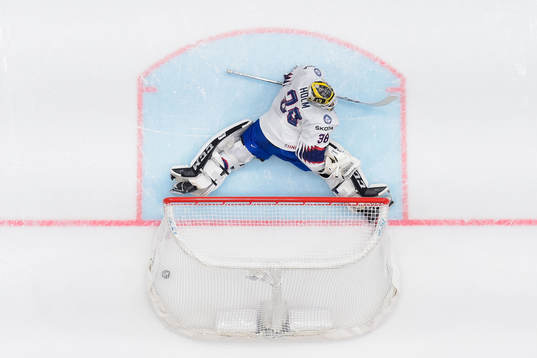 Goaltender Henrik Holm of Norway looks dejected