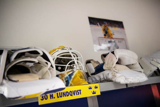 A goalie mask is seen above the changing area of goaltender