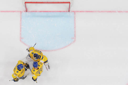 goaltender Henrik Lundqvist celebrates with Erik Gustafsson
