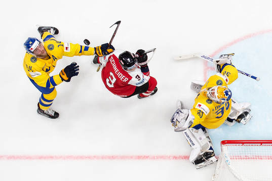 Mattias Ekholm and goaltender Henrik Lundqvist of Sweden in