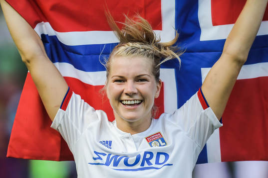 Ada Hegerberg of Lyon celebrates with a Norwegian flag