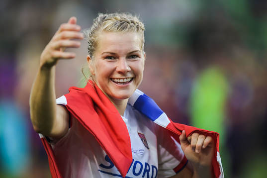 Ada Hegerberg of Lyon celebrates with a Norwegian flag