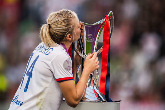 Ada Hegerberg of Lyon kisses the trophy