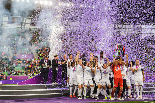 Players of Lyon celebrate with the trophy