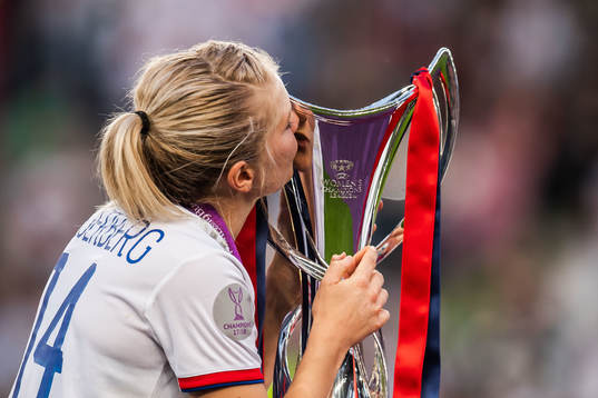Ada Hegerberg of Lyon kisses the trophy