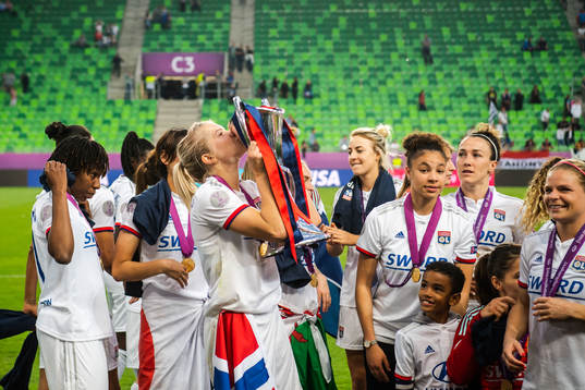 Ada Hegerberg of Lyon kisses the trophy