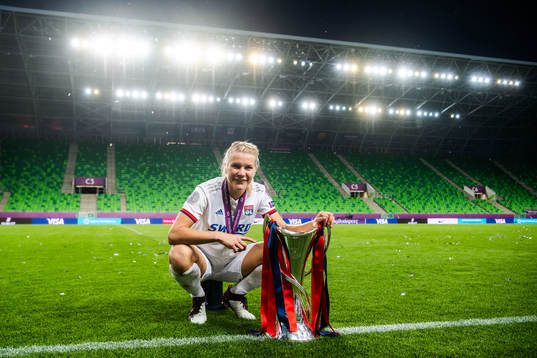 Ada Hegerberg of Lyon poses for a portrait with the trophy